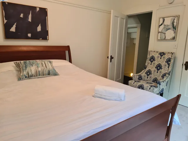 a bedroom with a bed and wall painting