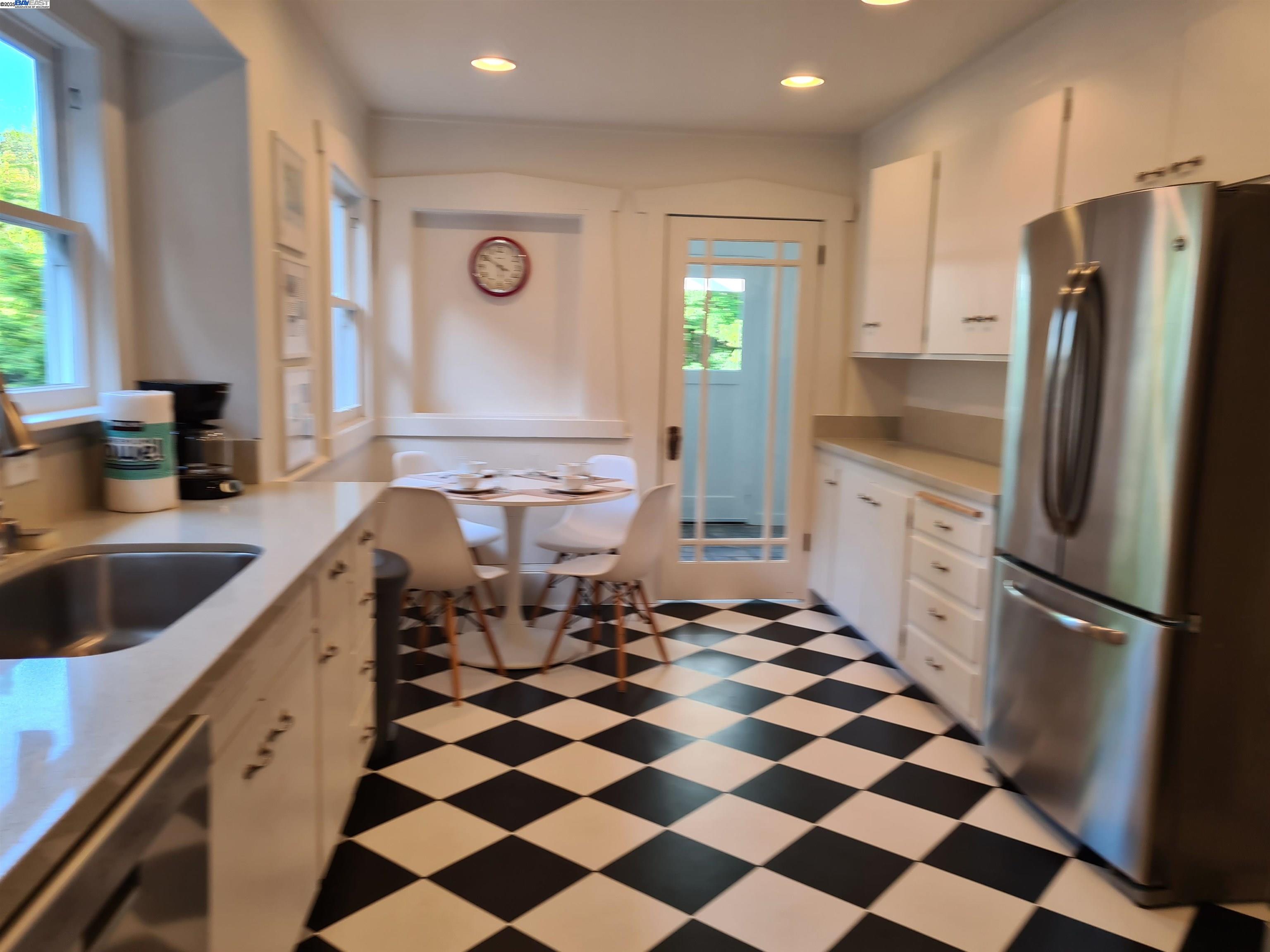 3103 Central Alameda, CA 94501 - Photo 16 of 50 a kitchen with a checkered floor and white cabinets