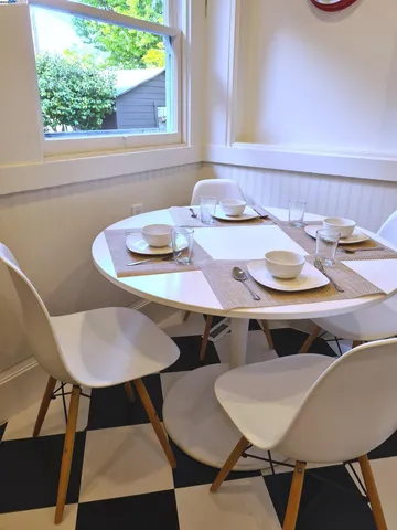 a dining room with furniture and window