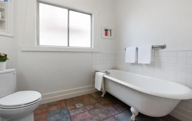 a bathroom with a toilet and bathtub
