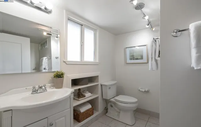 a bathroom with a toilet a sink and mirror