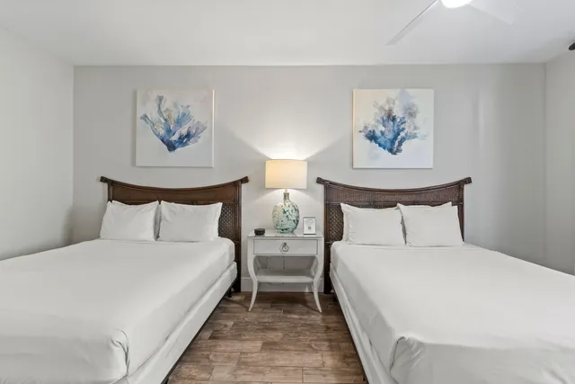 a bedroom with bed and a painting on the wall