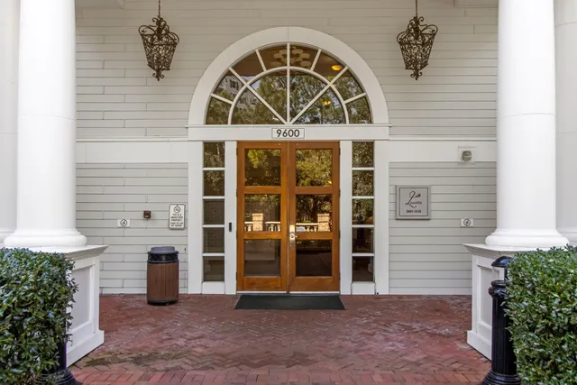 a living room with fireplace furniture and a chandelier