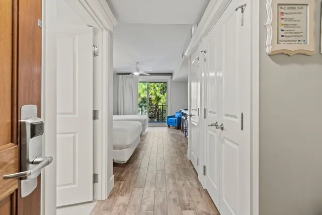 a view of a hallway with wooden floor and staircase