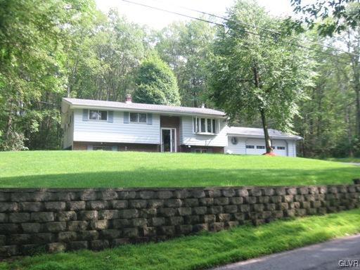5103 High Terrace Road Stroudsburg, PA 18360 - Photo 3 of 20 a front view of a house with a yard table and chairs