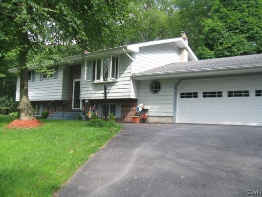 5103 High Terrace Road Stroudsburg, PA 18360 - Photo 7 of 20 a front view of a house with a garden and deck