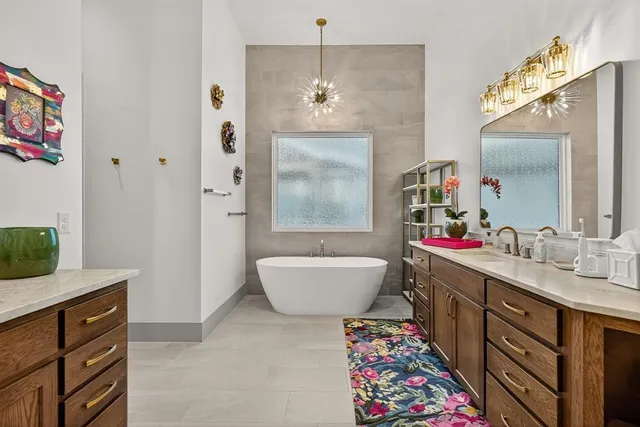 a bathroom with a bathtub sink and mirror