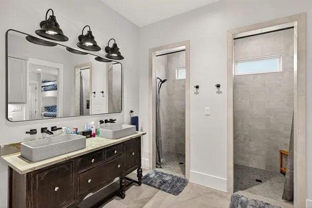 a bathroom with a sink vanity granite shower and a mirror
