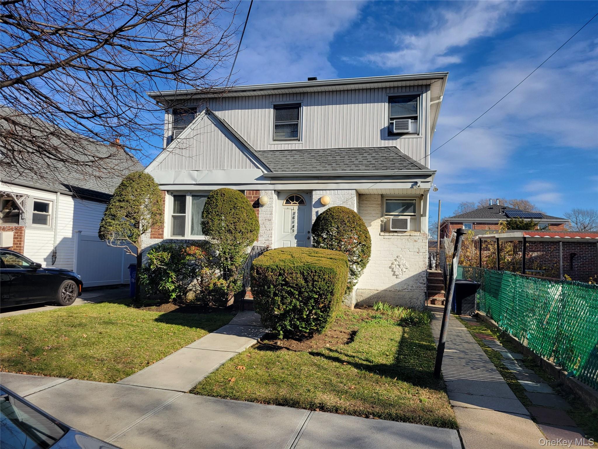 16-49 200th Street Queens, NY 11360 - Photo 2 of 8 a front view of a house with garden