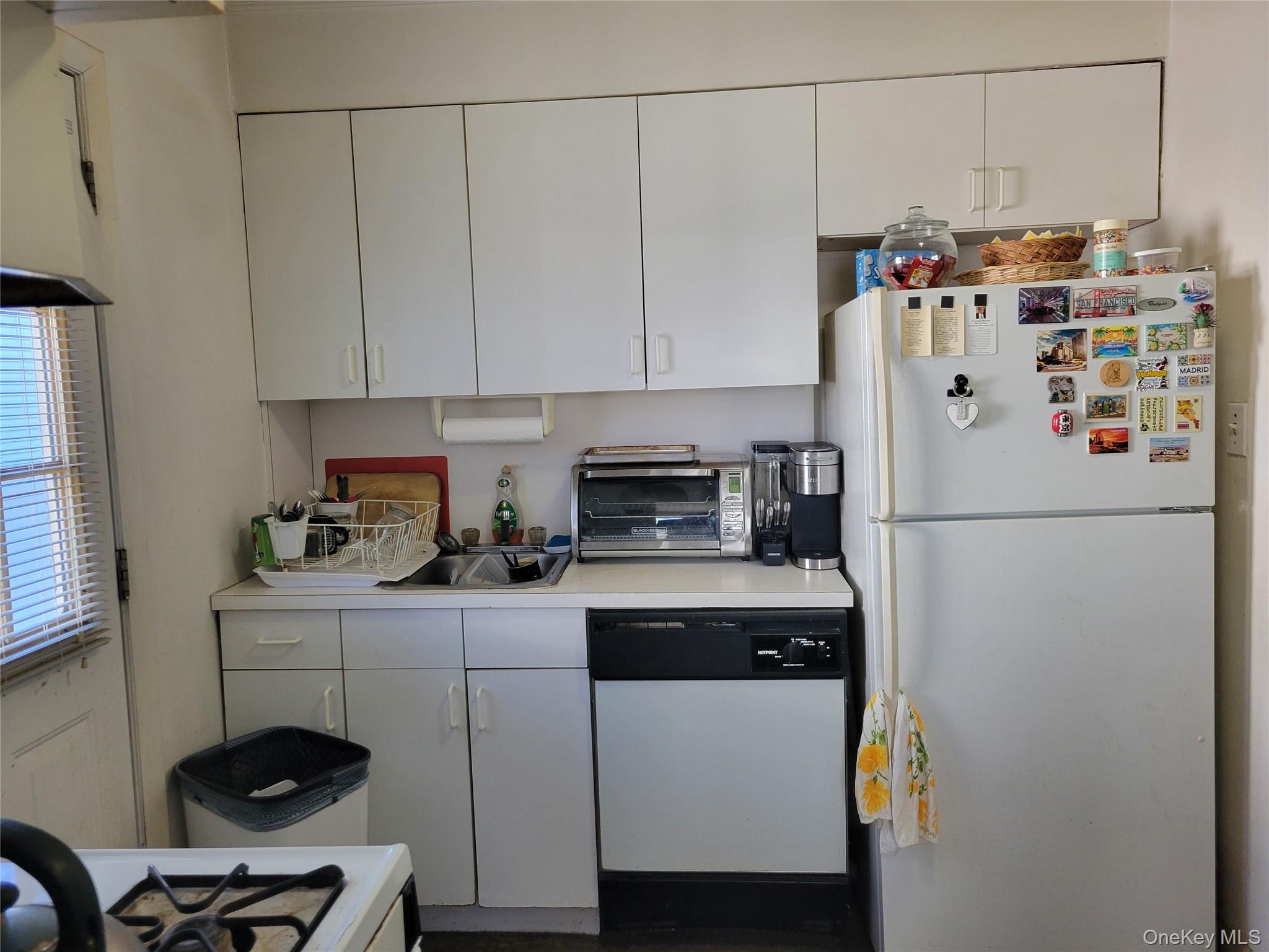 16-49 200th Street Queens, NY 11360 - Photo 6 of 8 a kitchen with a refrigerator and a stove top oven