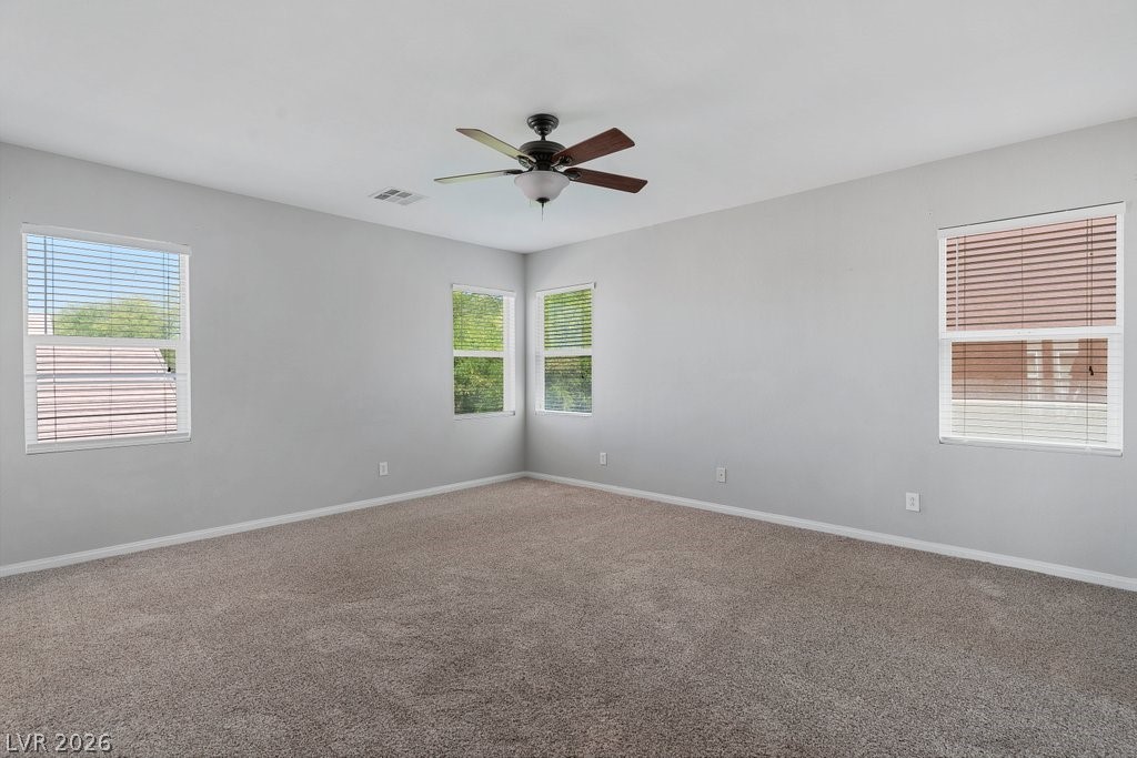 10336 Hawk Ravine Street Las Vegas, NV 89178 - Photo 27 of 59 This airy bedroom offers ample natural light and a comforting atmosphere for peaceful relaxation.