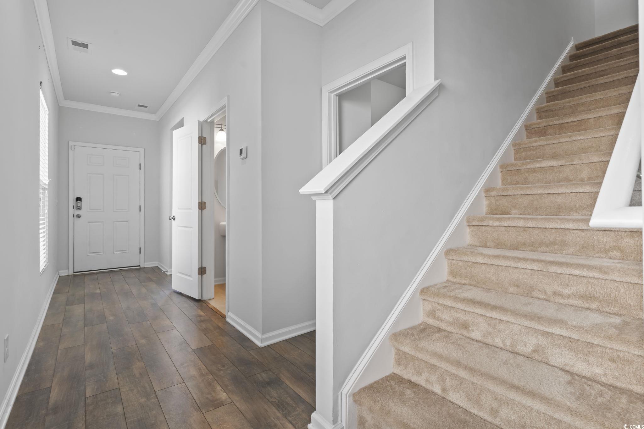 301 Castle Drive, Unit 301 Myrtle Beach, SC 29579 - Photo 11 of 30 Entryway featuring ornamental molding and dark har