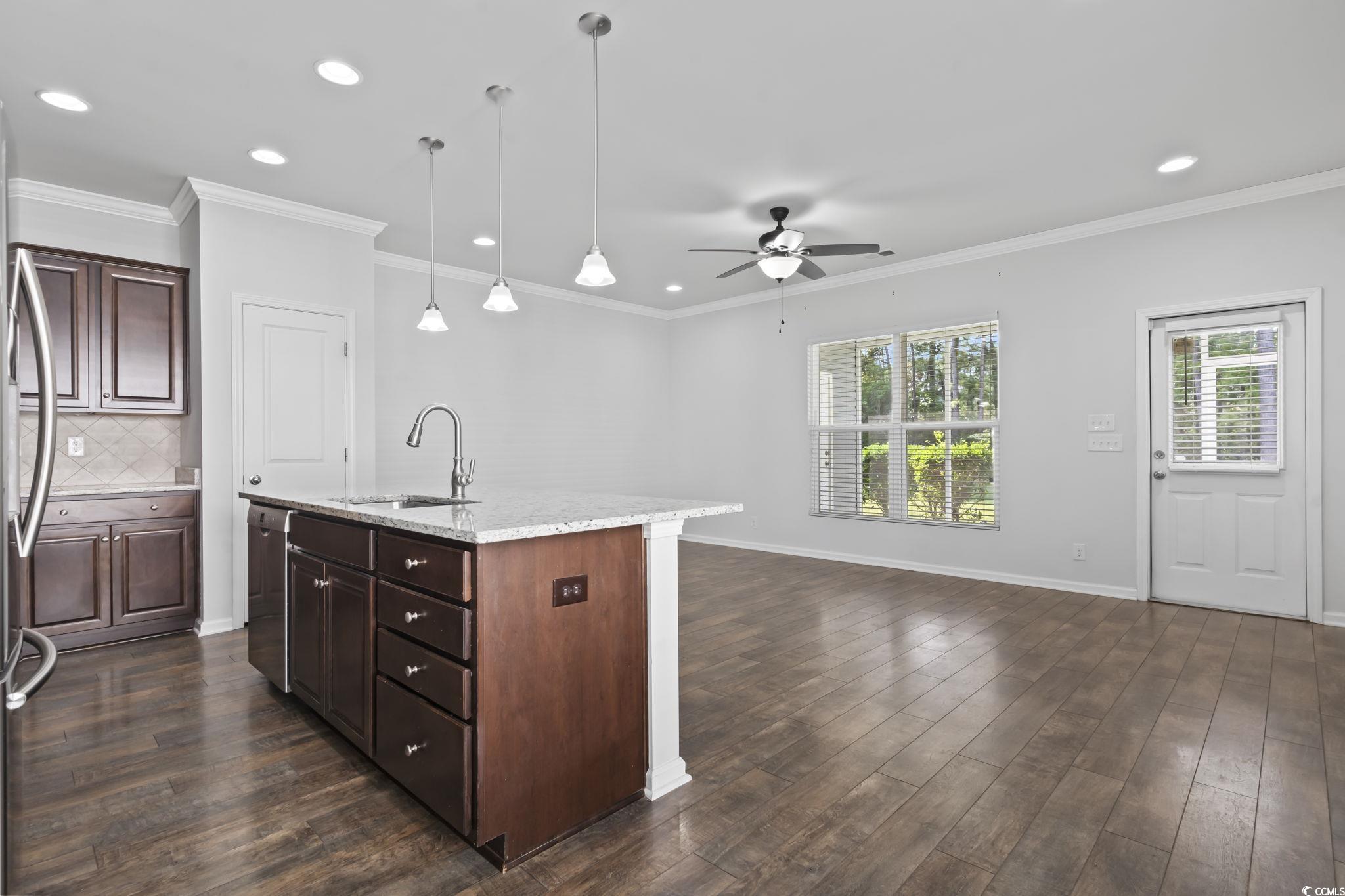 301 Castle Drive, Unit 301 Myrtle Beach, SC 29579 - Photo 12 of 30 Kitchen featuring a center island with sink, sink,