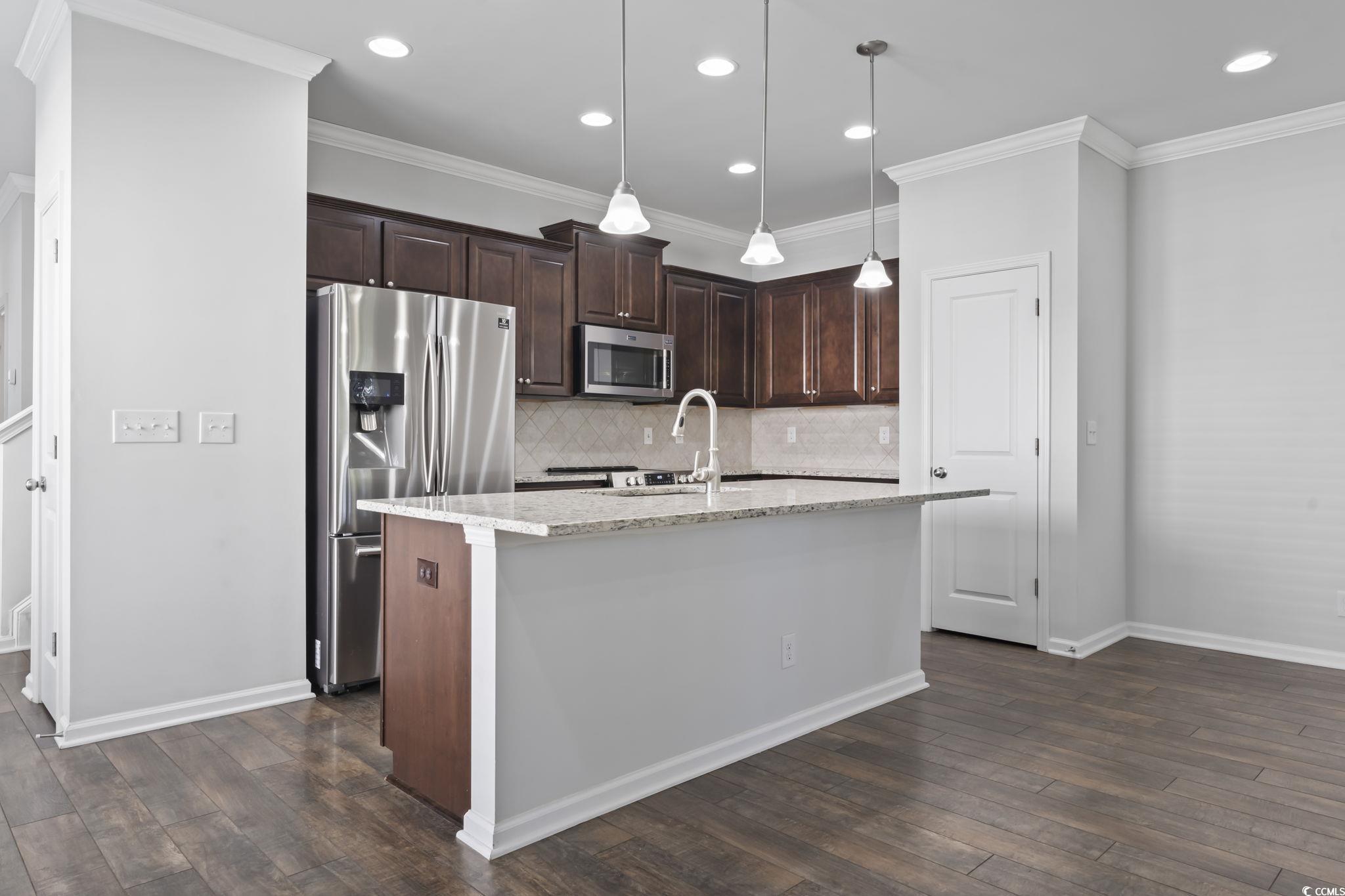 301 Castle Drive, Unit 301 Myrtle Beach, SC 29579 - Photo 13 of 30 Kitchen featuring a center island with sink, penda