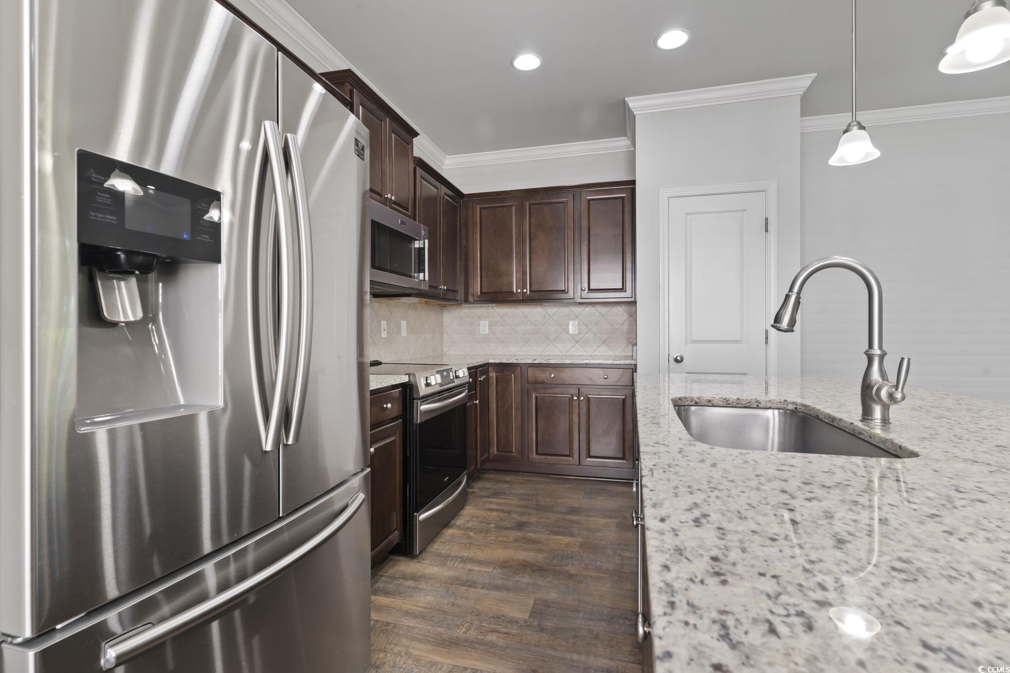 301 Castle Drive, Unit 301 Myrtle Beach, SC 29579 - Photo 16 of 30 Kitchen with pendant lighting, sink, stainless ste