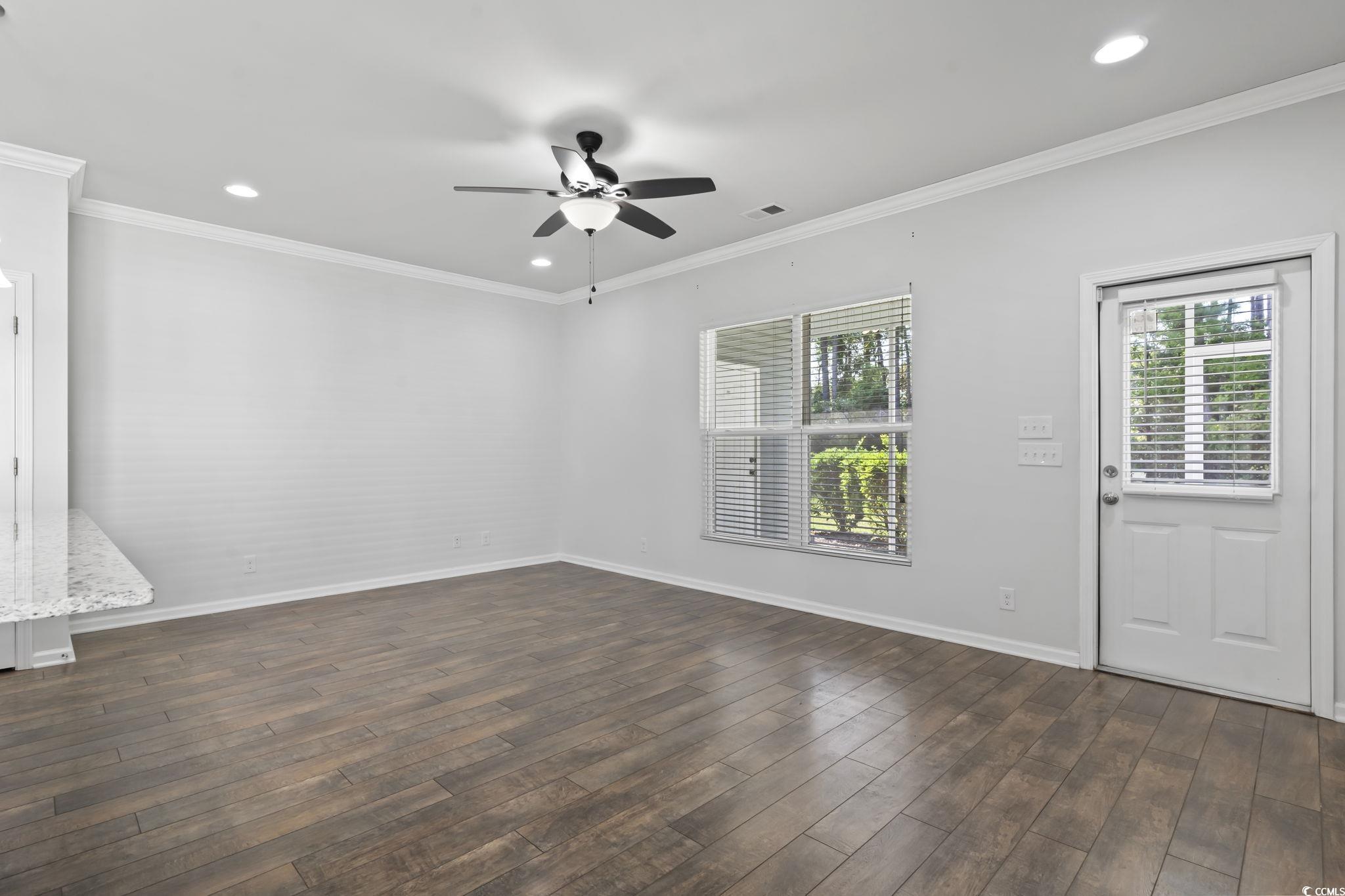 301 Castle Drive, Unit 301 Myrtle Beach, SC 29579 - Photo 17 of 30 Unfurnished room featuring crown molding, dark har