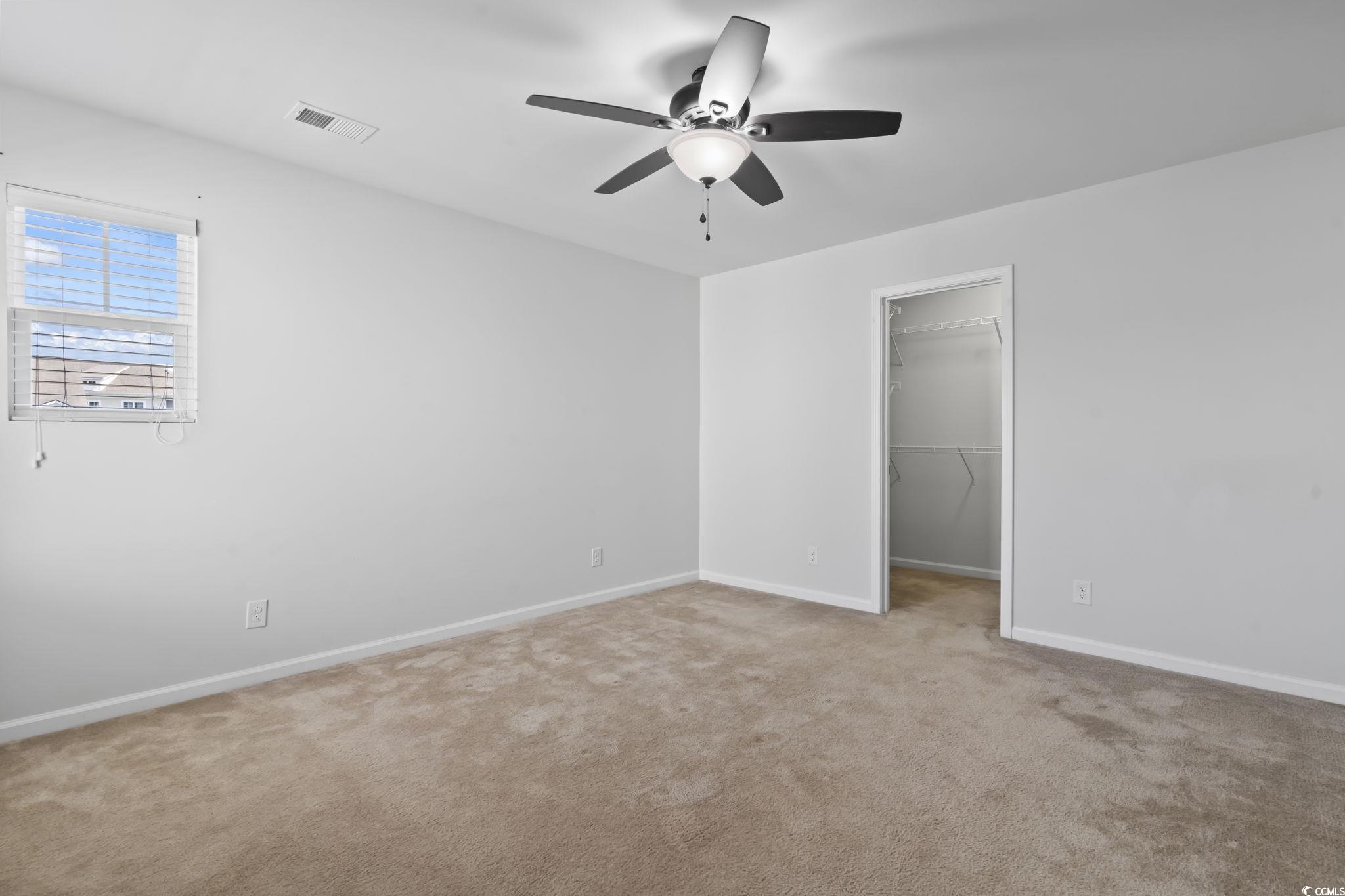 301 Castle Drive, Unit 301 Myrtle Beach, SC 29579 - Photo 21 of 30 Unfurnished bedroom featuring ceiling fan, a close