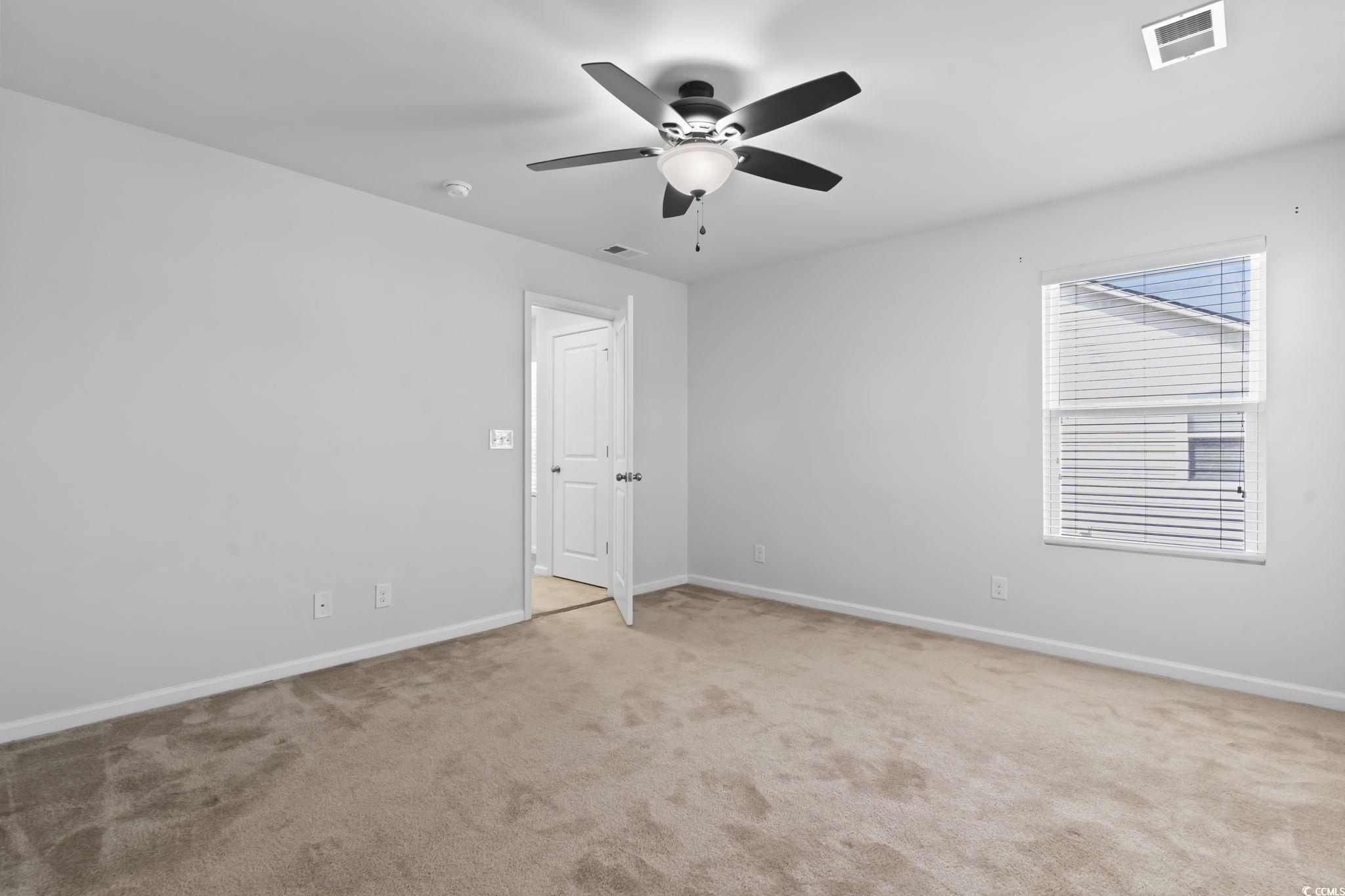 301 Castle Drive, Unit 301 Myrtle Beach, SC 29579 - Photo 22 of 30 Carpeted empty room featuring ceiling fan
