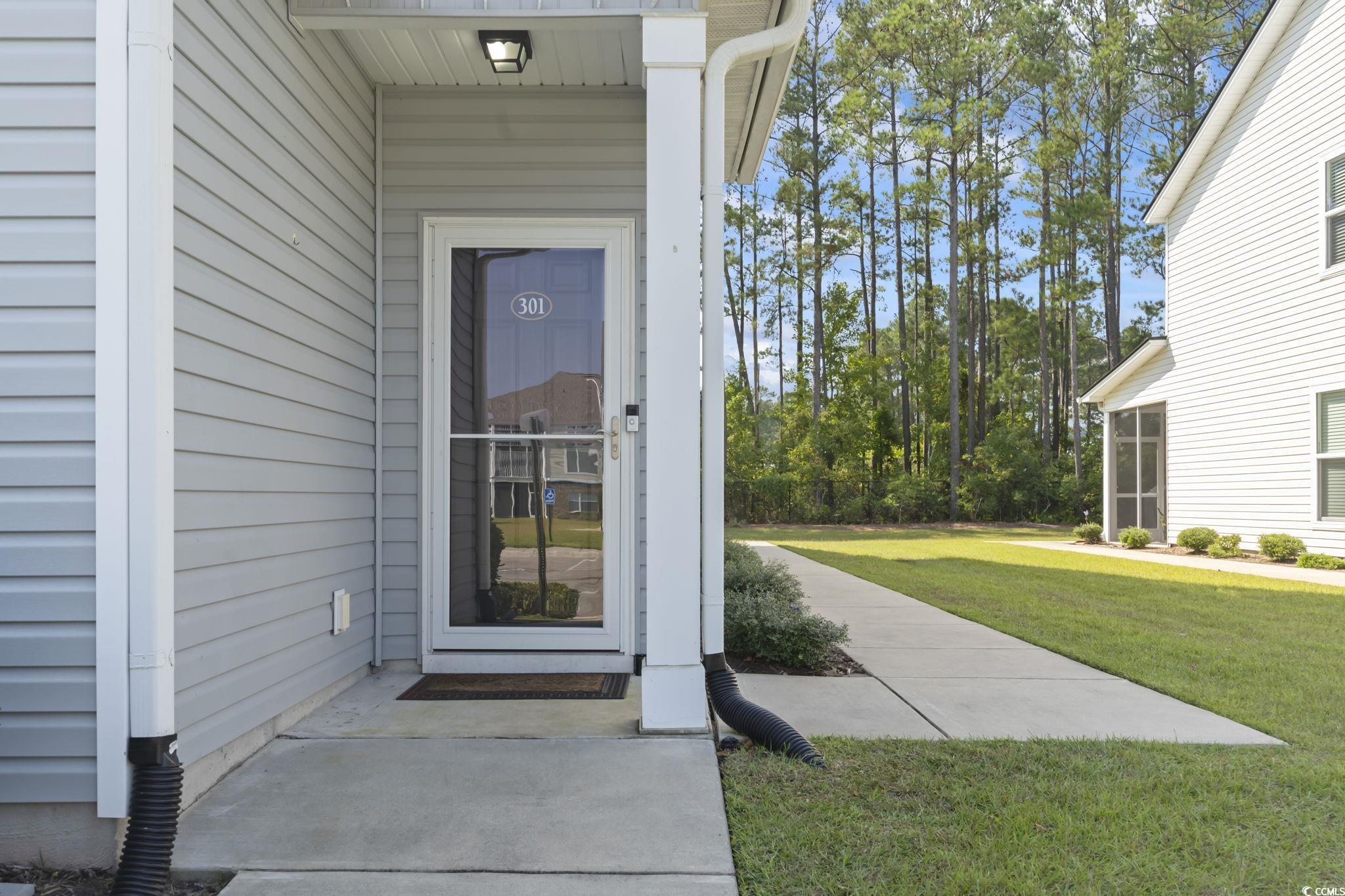 301 Castle Drive, Unit 301 Myrtle Beach, SC 29579 - Photo 26 of 30 Property entrance with a yard