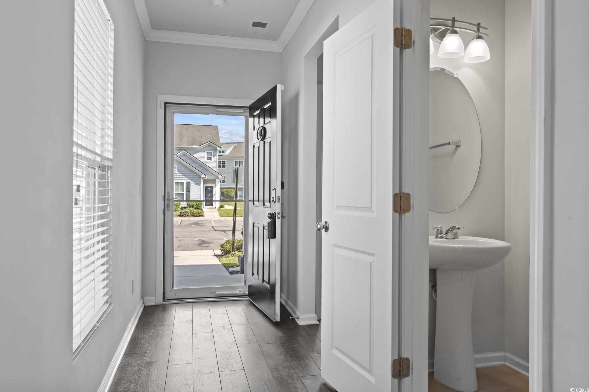 301 Castle Drive, Unit 301 Myrtle Beach, SC 29579 - Photo 5 of 30 Doorway to outside featuring ornamental molding, s