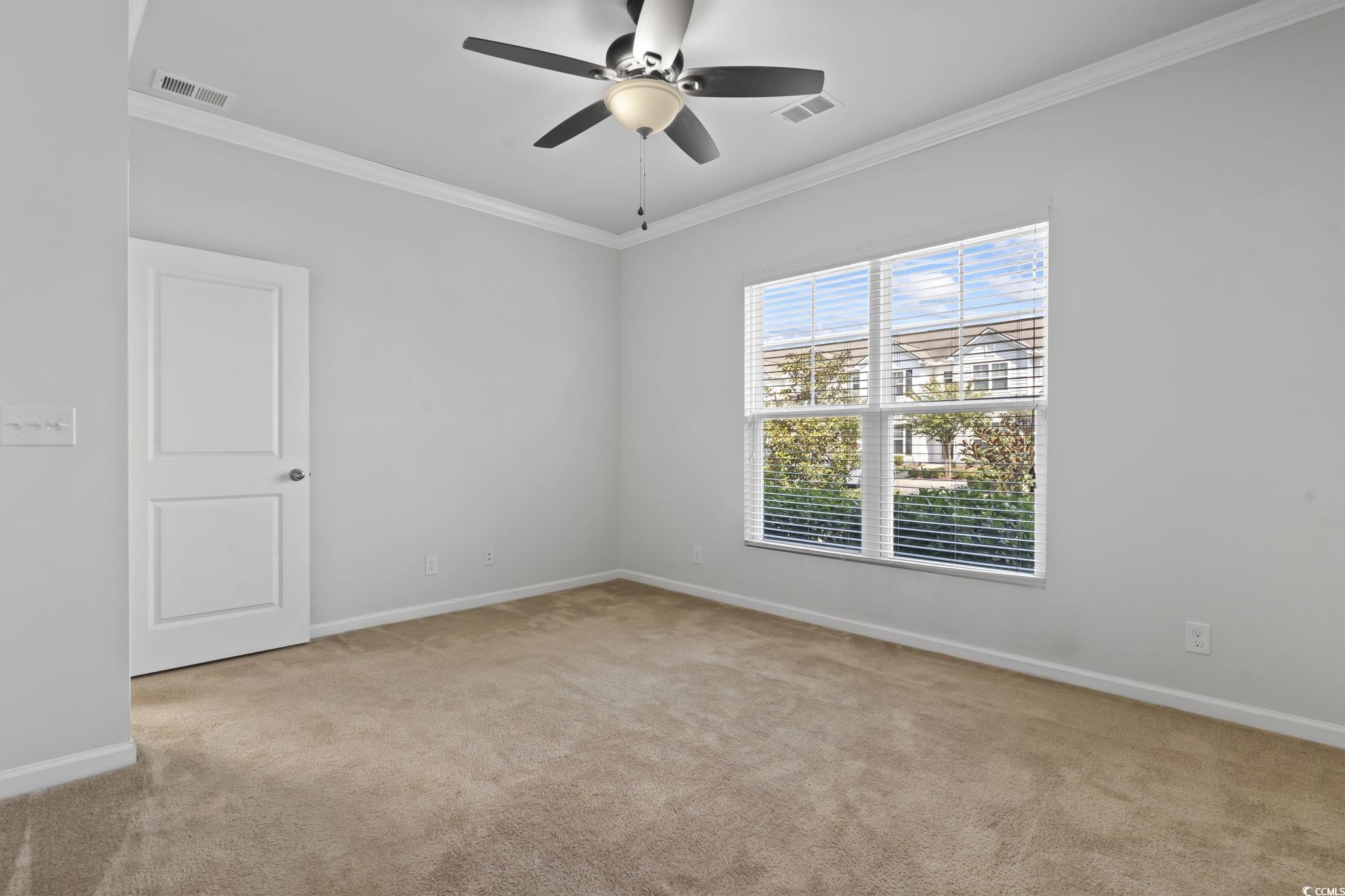 301 Castle Drive, Unit 301 Myrtle Beach, SC 29579 - Photo 7 of 30 Spare room with light carpet, crown molding, and c