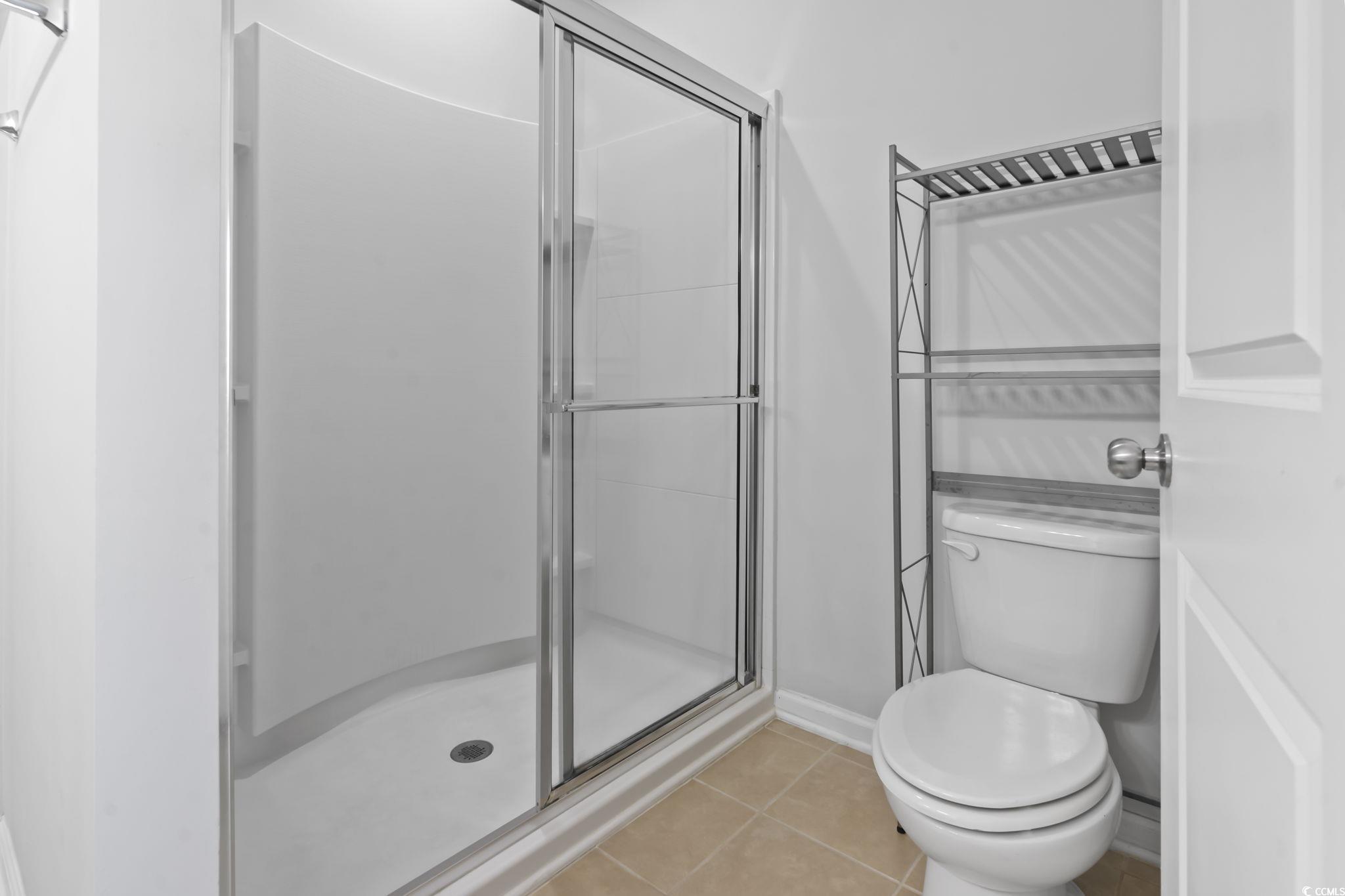 301 Castle Drive, Unit 301 Myrtle Beach, SC 29579 - Photo 9 of 30 Bathroom with an enclosed shower, tile patterned f
