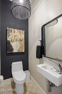 a bathroom with a sink toilet and a mirror