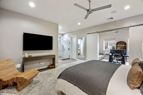 a bedroom with a bed and a flat screen tv