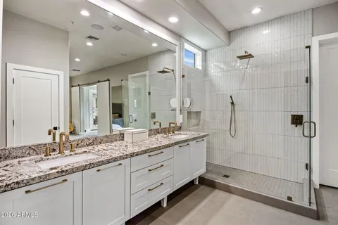a bathroom with a granite countertop sink mirror and double