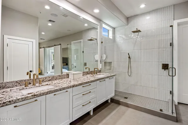 a bathroom with a granite countertop sink mirror and double