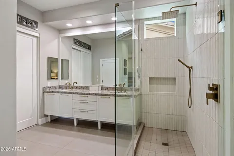 a bathroom with a shower sink and mirror