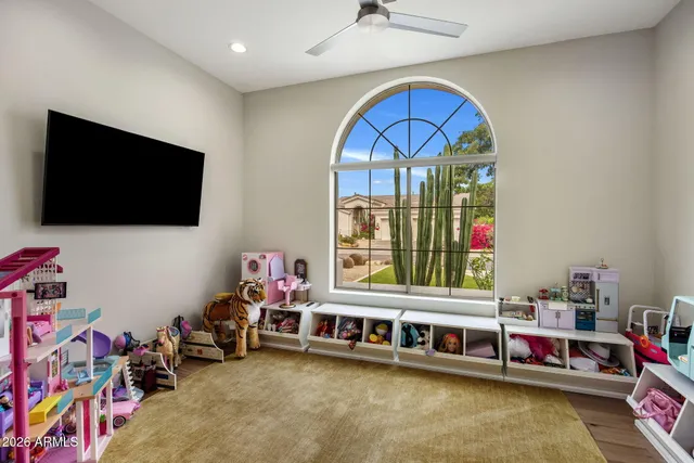 a bedroom with furniture and a flat screen tv
