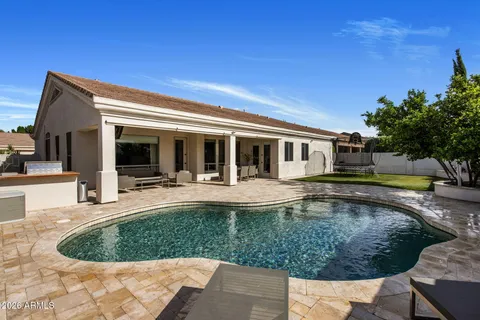 a view of a house with swimming pool and sitting area