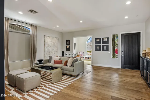 a living room with furniture and wooden floor