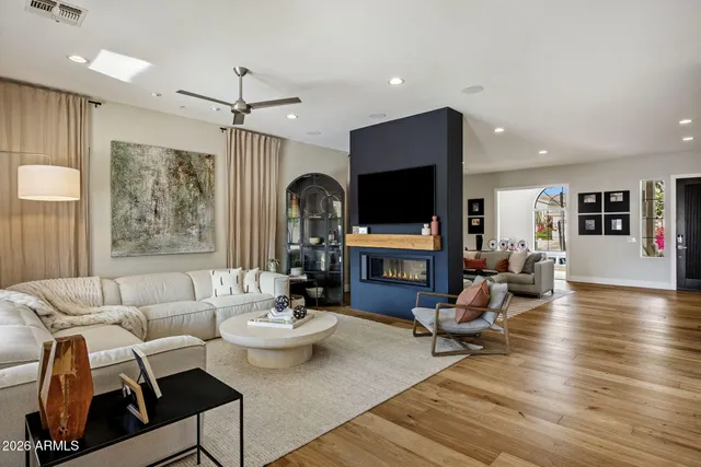 a living room with furniture a fireplace and a flat screen tv