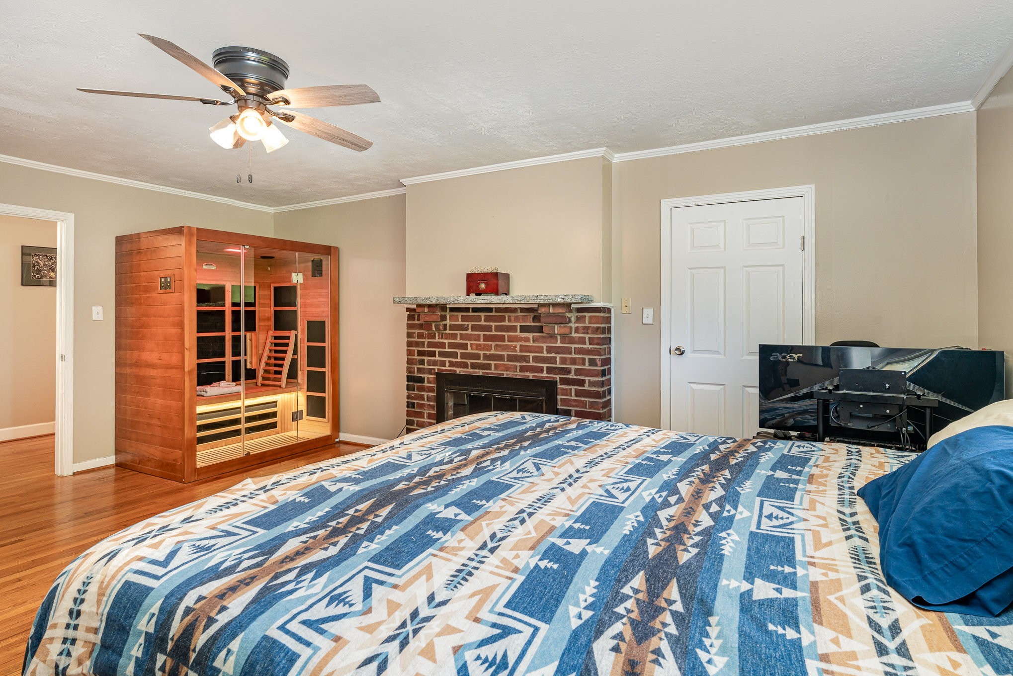 1029 Cumberland Heights Road Clarksville, TN 37040 - Photo 12 of 34 a bedroom with a bed and dresser with wooden floor