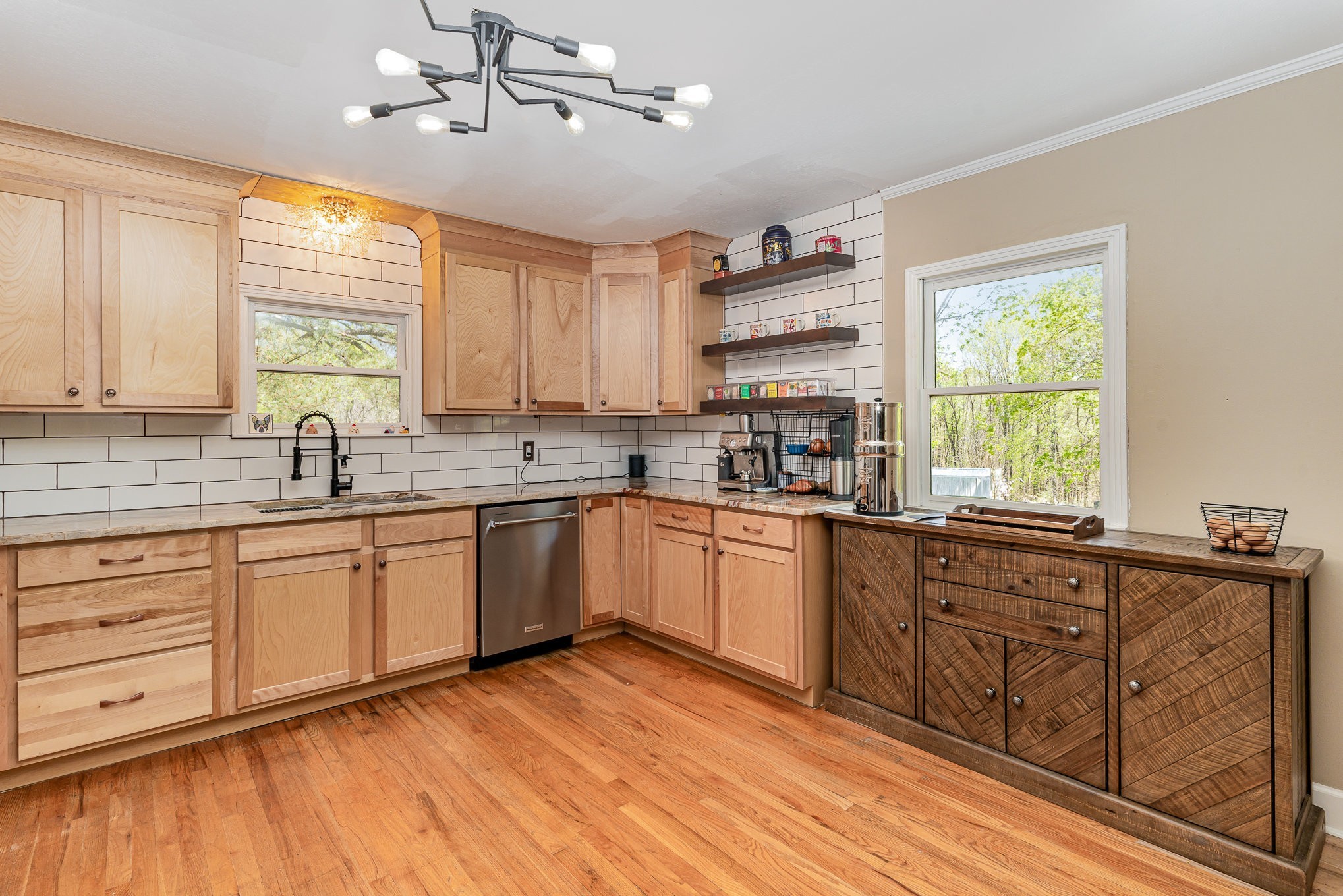 1029 Cumberland Heights Road Clarksville, TN 37040 - Photo 3 of 34 a large kitchen with granite countertop a stove a sink dishwasher and white cabinets with wooden floor
