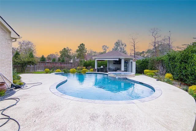 swimming pool view with a garden space