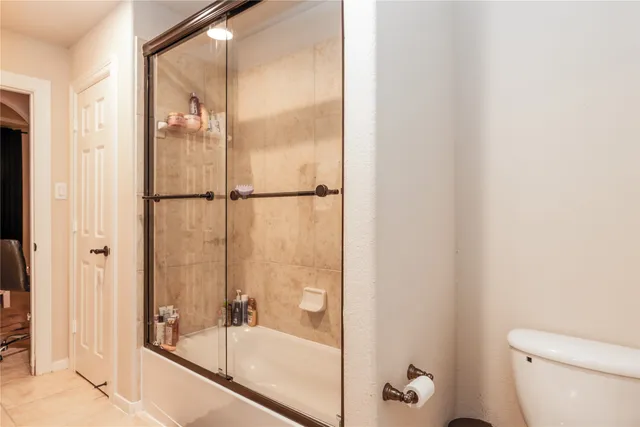 a bathroom with a glass shower door