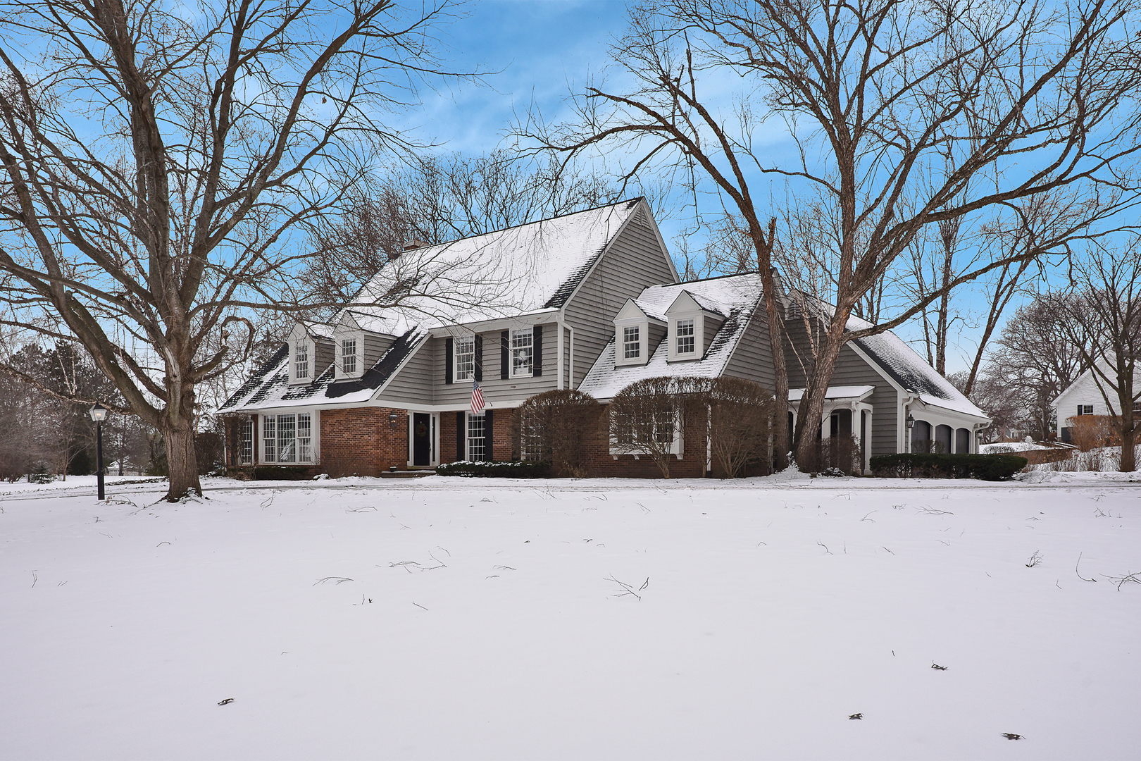 a view of a house with a yard covered in snow