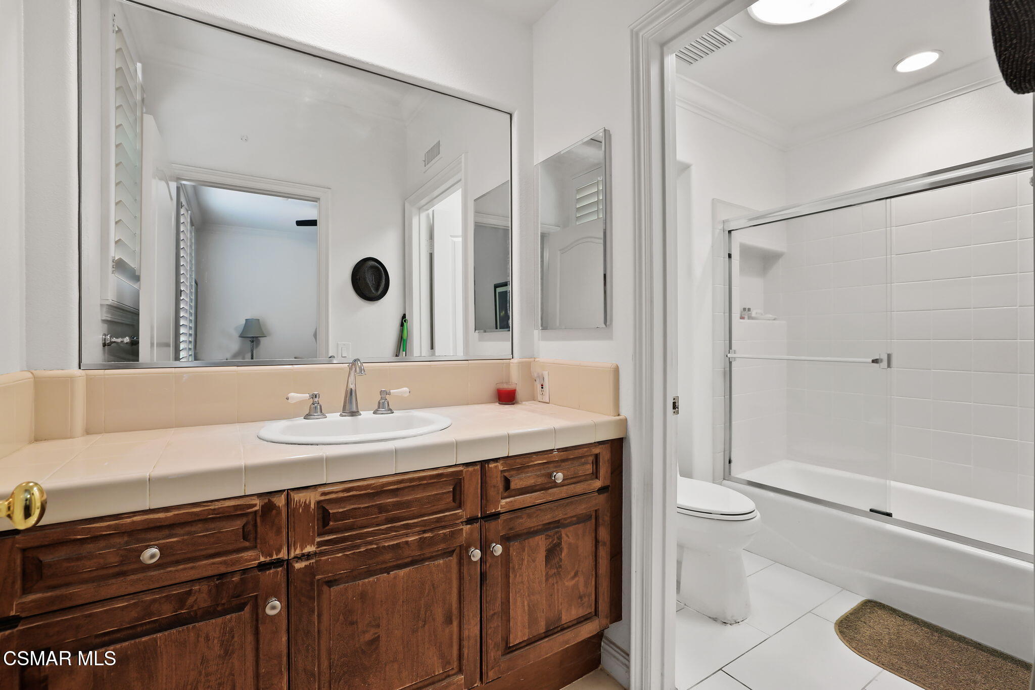 20253 Vía Galileo Porter Ranch, CA 91326 - Photo 13 of 41 a bathroom with a granite countertop sink toilet a large mirror and shower