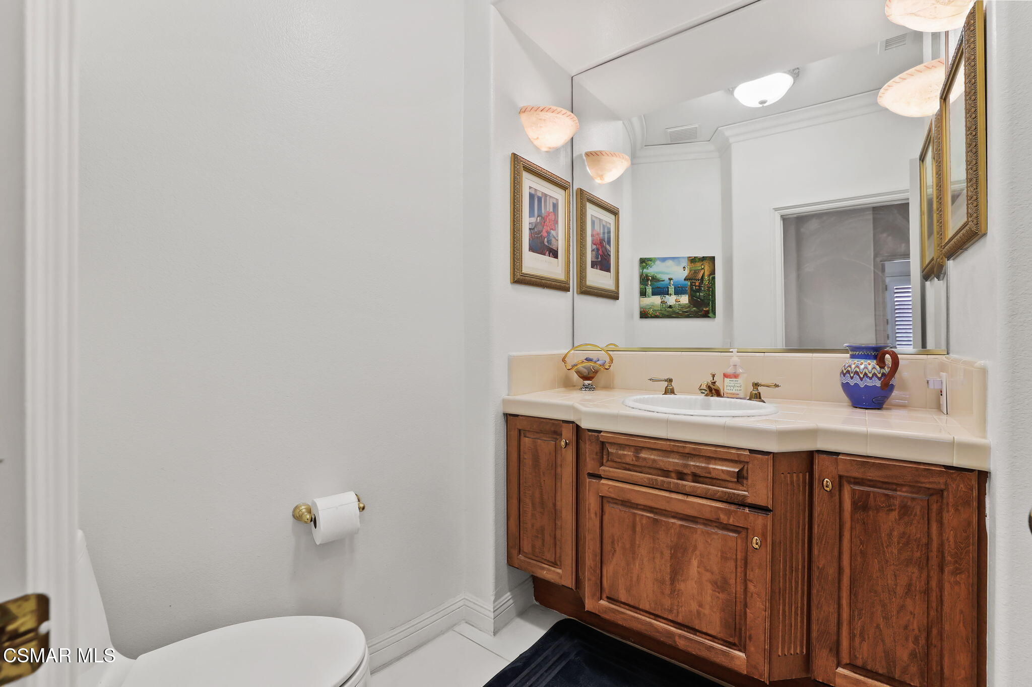20253 Vía Galileo Porter Ranch, CA 91326 - Photo 17 of 41 a bathroom with a toilet a sink and mirror