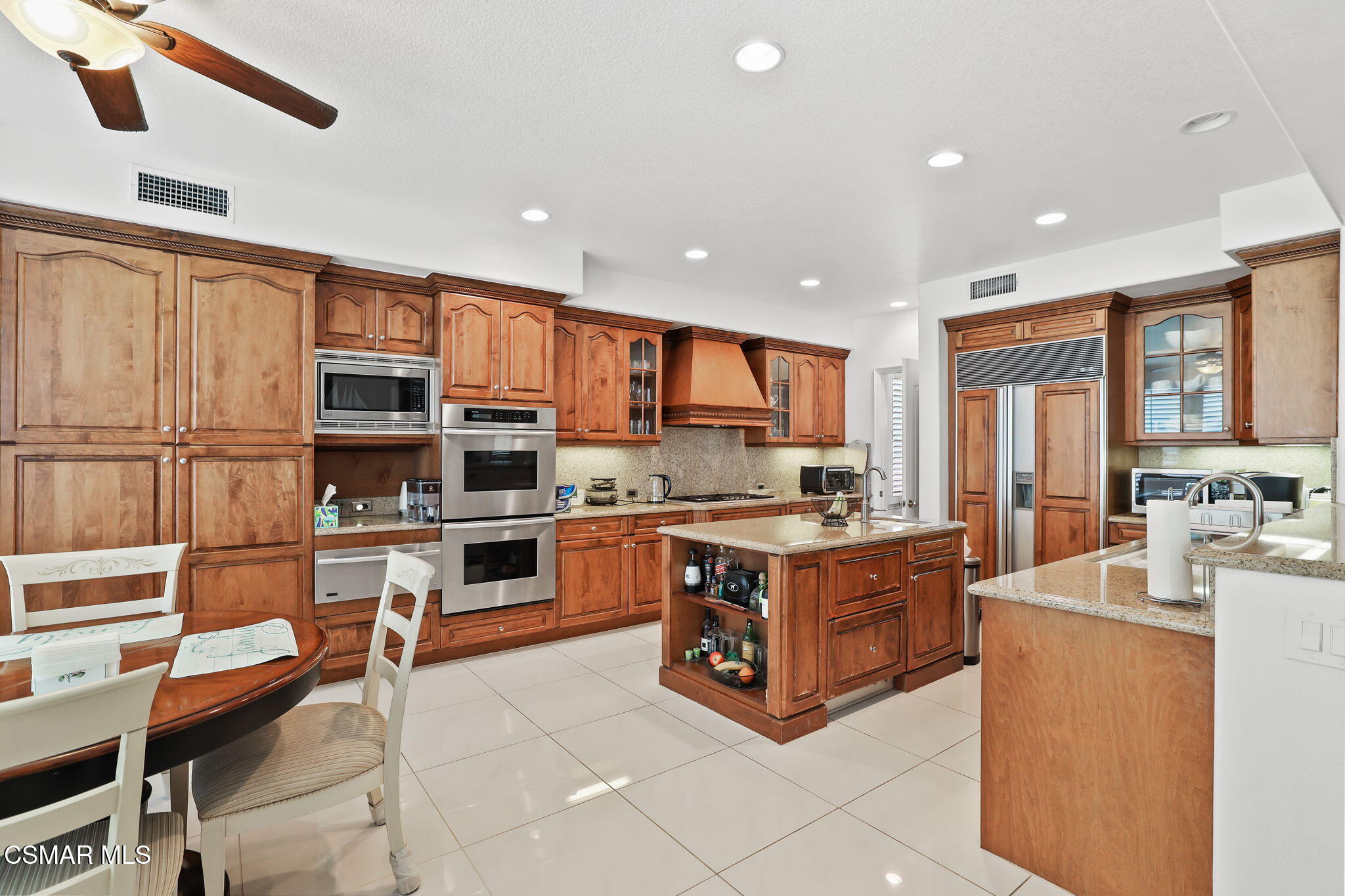 20253 Vía Galileo Porter Ranch, CA 91326 - Photo 9 of 41 a large kitchen with stainless steel appliances granite countertop a stove and a refrigerator