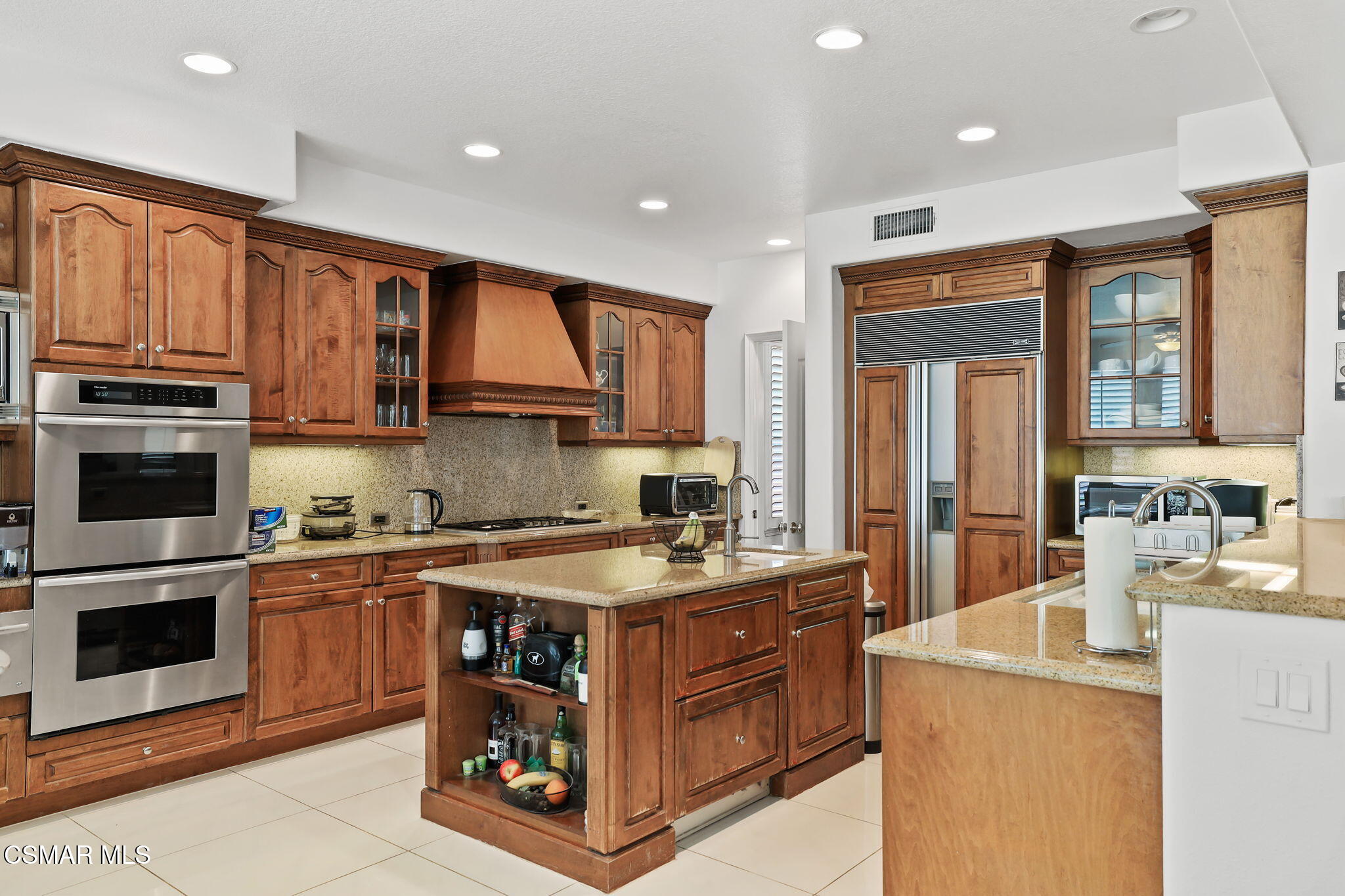 20253 Vía Galileo Porter Ranch, CA 91326 - Photo 10 of 41 a kitchen with kitchen island granite countertop a sink stove and cabinets