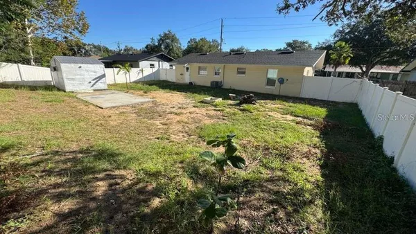 a view of a backyard of the house