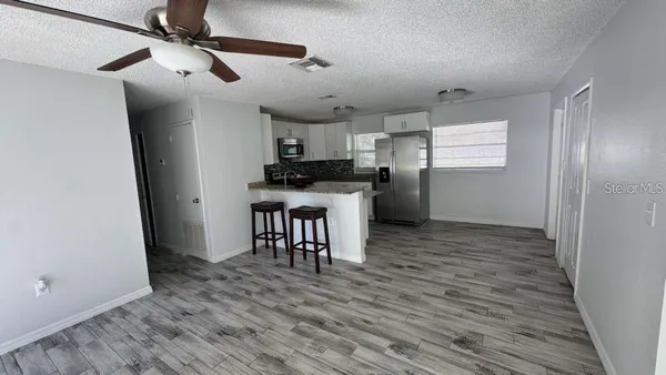a kitchen with stainless steel appliances a refrigerator and a stove