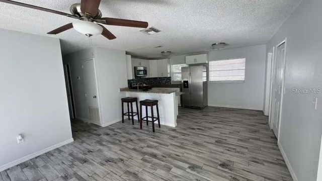 a kitchen with stainless steel appliances a refrigerator and a stove