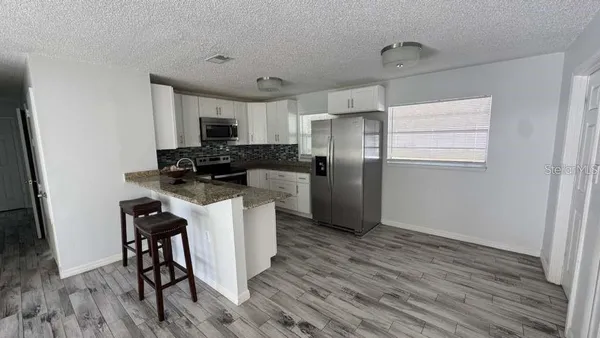 a kitchen with a refrigerator a stove top oven a sink and dishwasher