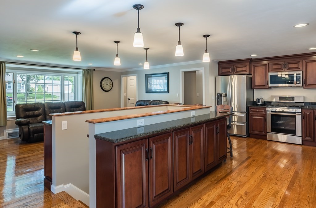 2 East Colonial Road Wilbraham, MA 01095 - Photo 11 of 42 a kitchen with stainless steel appliances wooden cabinets a stove a sink and a refrigerator