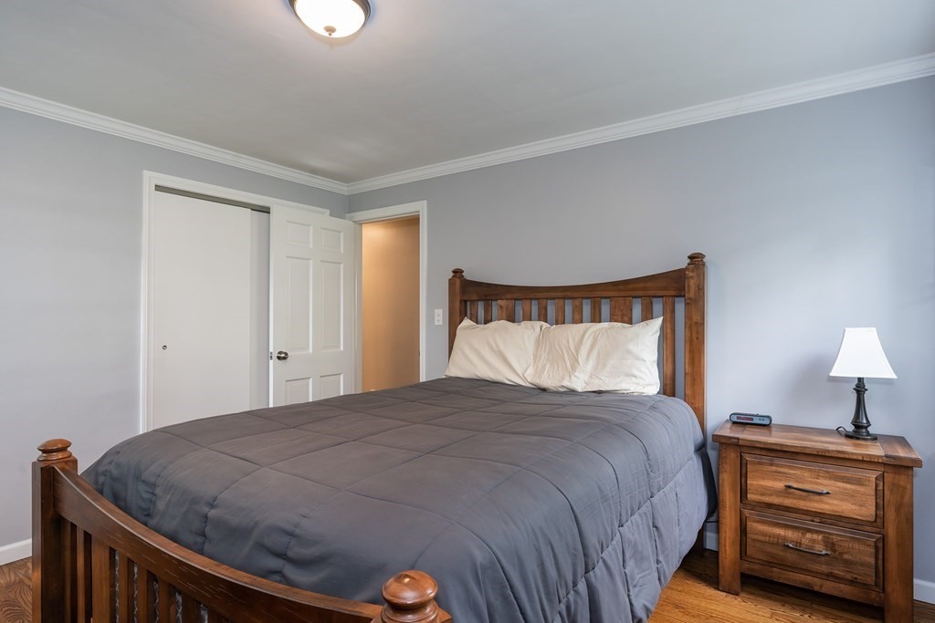 2 East Colonial Road Wilbraham, MA 01095 - Photo 17 of 42 a bedroom with a bed and a lamp on dresser